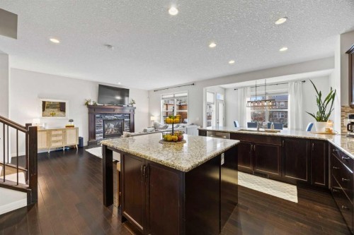 40 Chaparral Valley Green Se, Calgary, AB - Indoor Photo Showing Kitchen With Fireplace
