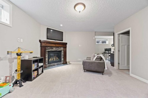 40 Chaparral Valley Green Se, Calgary, AB - Indoor Photo Showing Living Room With Fireplace