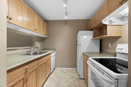 2113-2113 Tuscarora Manor Nw, Calgary, AB - Indoor Photo Showing Kitchen With Double Sink