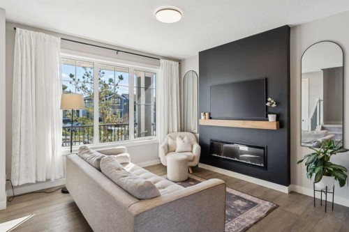 377 Sundown Road, Cochrane, AB - Indoor Photo Showing Living Room With Fireplace