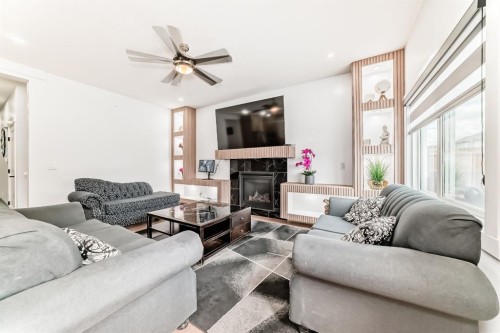 127 Saddlecrest Grove Ne, Calgary, AB - Indoor Photo Showing Living Room With Fireplace