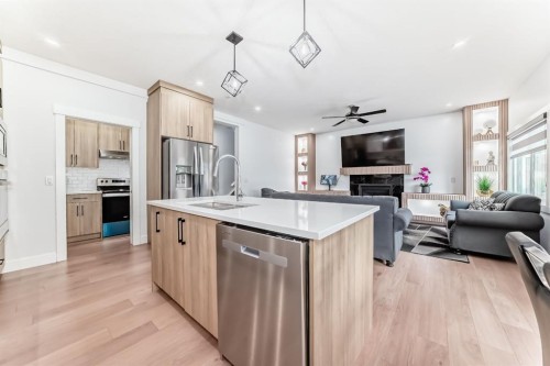 127 Saddlecrest Grove Ne, Calgary, AB - Indoor Photo Showing Kitchen With Fireplace With Upgraded Kitchen