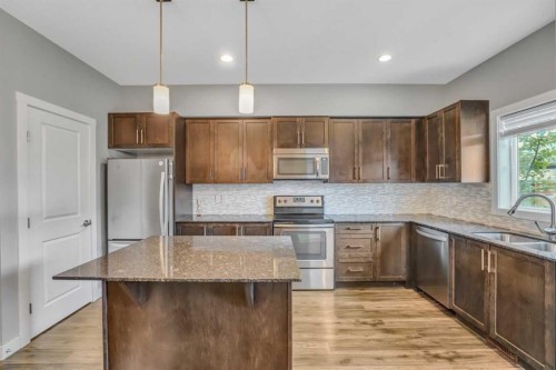 315 Hillcrest Drive Sw, Airdrie, AB - Indoor Photo Showing Kitchen With Stainless Steel Kitchen With Double Sink
