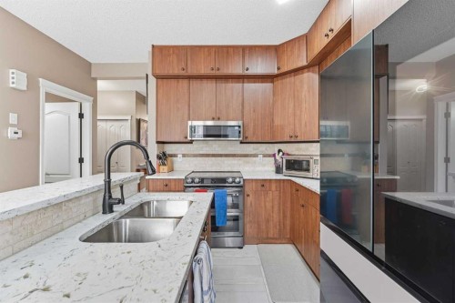23 Prestwick Park Se, Calgary, AB - Indoor Photo Showing Kitchen With Stainless Steel Kitchen With Double Sink With Upgraded Kitchen