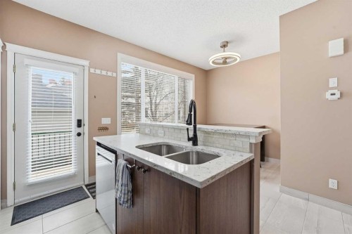 23 Prestwick Park Se, Calgary, AB - Indoor Photo Showing Kitchen With Double Sink