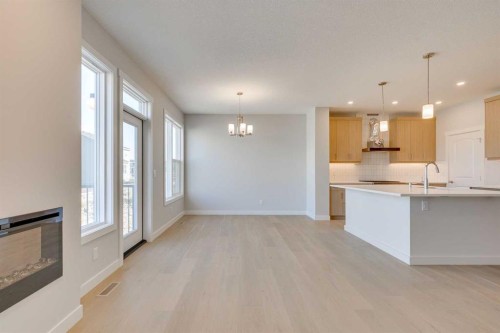 157 Wolf Hollow Drive Se, Calgary, AB - Indoor Photo Showing Kitchen With Fireplace
