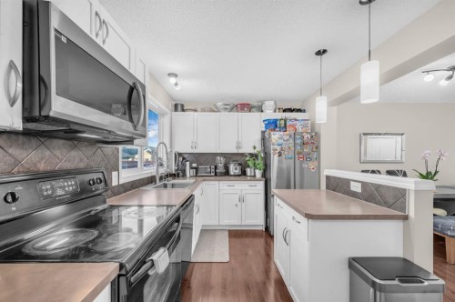 207 Elgin Meadows Se, Calgary, AB - Indoor Photo Showing Kitchen With Double Sink