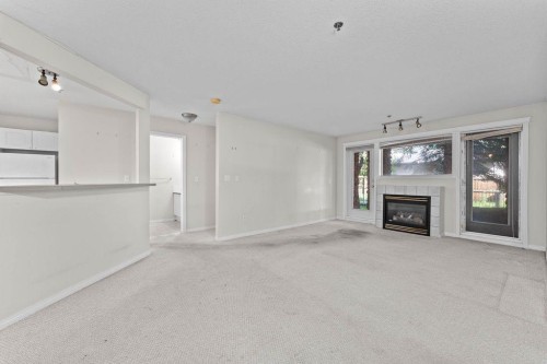109-4507 45 Street Sw, Calgary, AB - Indoor Photo Showing Other Room With Fireplace