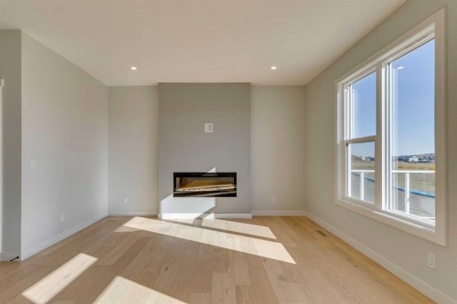 143 Creekstone Green Sw, Calgary, AB - Indoor Photo Showing Other Room With Fireplace