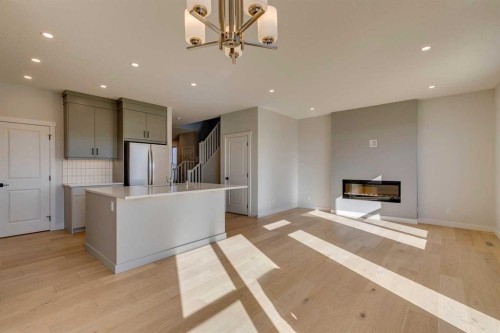 143 Creekstone Green Sw, Calgary, AB - Indoor Photo Showing Kitchen With Fireplace