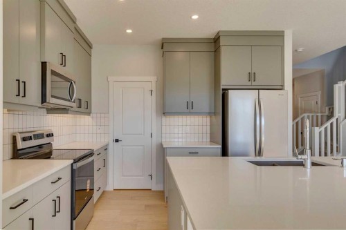 143 Creekstone Green Sw, Calgary, AB - Indoor Photo Showing Kitchen With Upgraded Kitchen