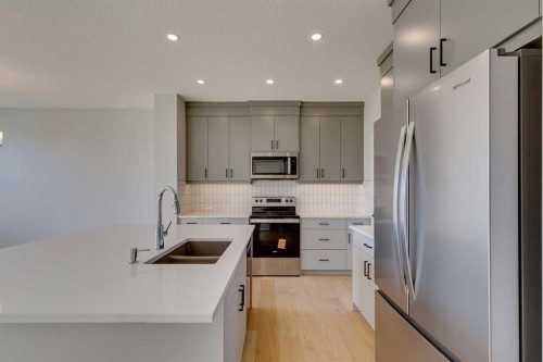 143 Creekstone Green Sw, Calgary, AB - Indoor Photo Showing Kitchen With Double Sink With Upgraded Kitchen
