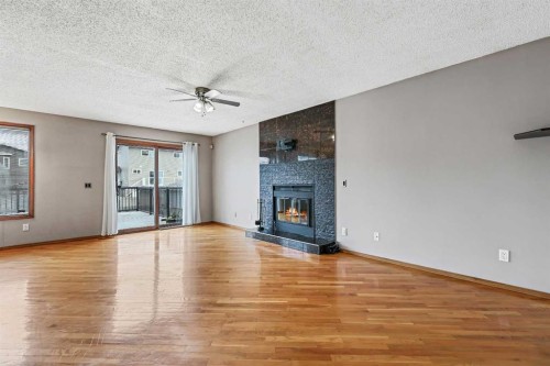 128 Ventura Way Ne, Calgary, AB - Indoor Photo Showing Living Room With Fireplace