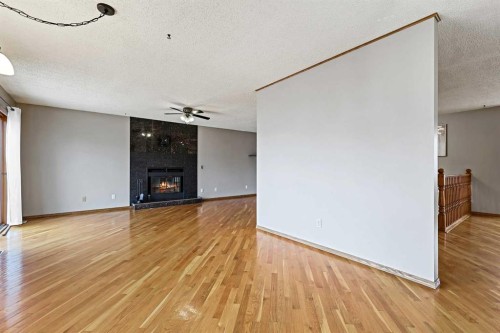128 Ventura Way Ne, Calgary, AB - Indoor Photo Showing Other Room With Fireplace
