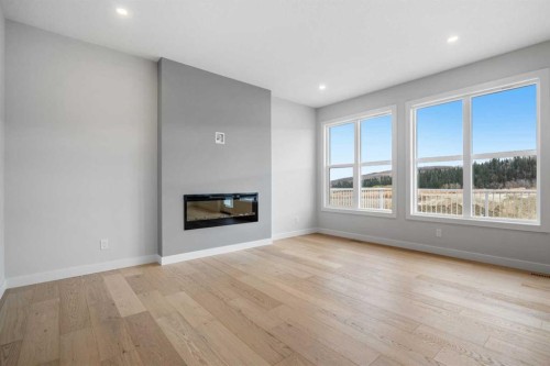 76 Creekview Manor Sw, Calgary, AB - Indoor Photo Showing Living Room With Fireplace
