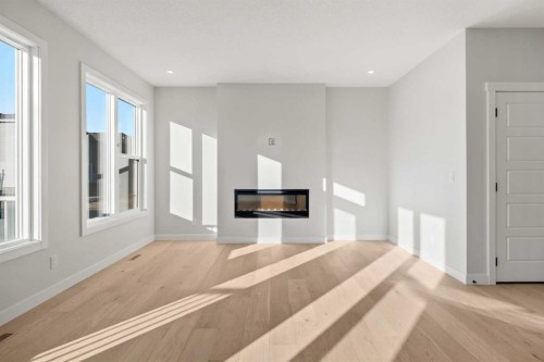 63 Creekstone Common Sw, Calgary, AB - Indoor Photo Showing Other Room With Fireplace