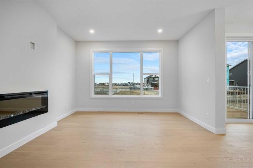 56 Creekstone Grove Sw, Calgary, AB - Indoor Photo Showing Other Room With Fireplace