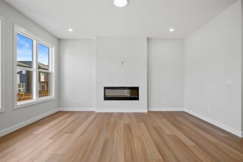 38 Amblefield Common Nw, Calgary, AB - Indoor Photo Showing Living Room With Fireplace