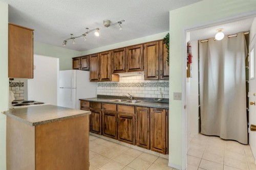 127 Falshire Way Ne, Calgary, AB - Indoor Photo Showing Kitchen With Double Sink