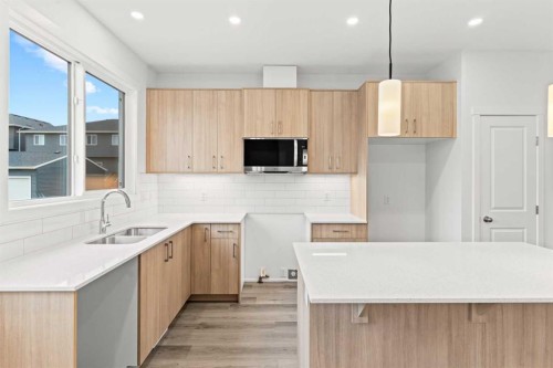 918 Creekside Boulevard Sw, Calgary, AB - Indoor Photo Showing Kitchen With Double Sink