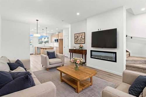 918 Creekside Boulevard Sw, Calgary, AB - Indoor Photo Showing Living Room With Fireplace