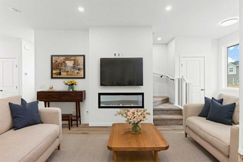 918 Creekside Boulevard Sw, Calgary, AB - Indoor Photo Showing Living Room With Fireplace