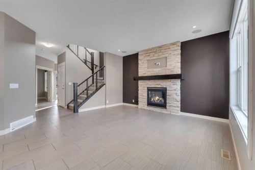 204 Sunset View, Cochrane, AB - Indoor Photo Showing Other Room With Fireplace