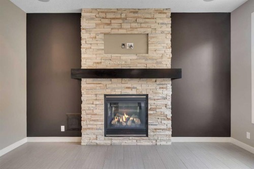 204 Sunset View, Cochrane, AB - Indoor Photo Showing Living Room With Fireplace