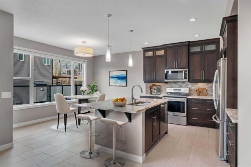 204 Sunset View, Cochrane, AB - Indoor Photo Showing Kitchen With Upgraded Kitchen