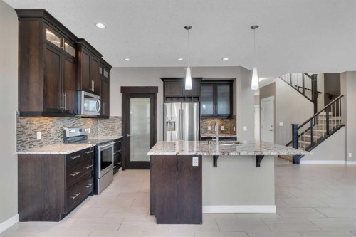 204 Sunset View, Cochrane, AB - Indoor Photo Showing Kitchen With Upgraded Kitchen