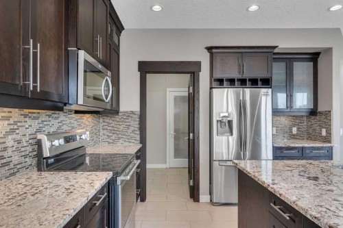 204 Sunset View, Cochrane, AB - Indoor Photo Showing Kitchen With Upgraded Kitchen
