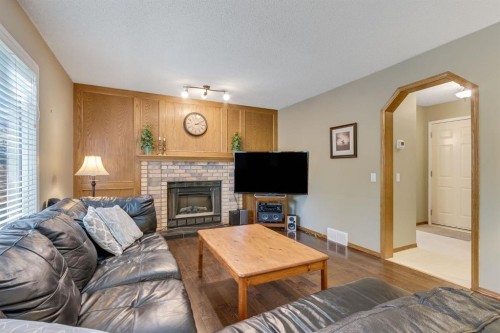 212 Mckerrell Way Se, Calgary, AB - Indoor Photo Showing Living Room With Fireplace