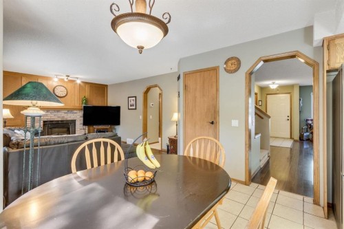 212 Mckerrell Way Se, Calgary, AB - Indoor Photo Showing Dining Room With Fireplace