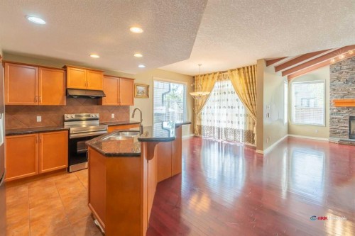 94 Kincora Gardens Nw, Calgary, AB - Indoor Photo Showing Kitchen With Fireplace