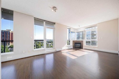 707-77 Spruce Place Sw, Calgary, AB - Indoor Photo Showing Living Room With Fireplace