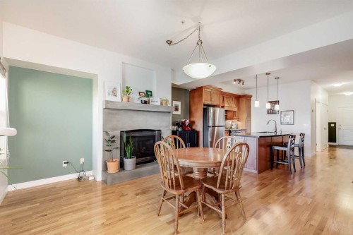 206-1818 14 Street Sw, Calgary, AB - Indoor Photo Showing Dining Room With Fireplace