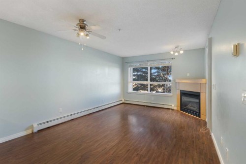 213-5115 Richard Road Sw, Calgary, AB - Indoor With Fireplace