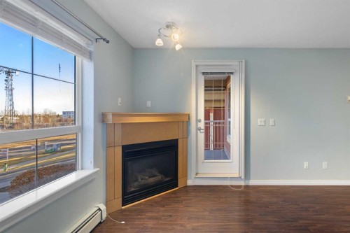 213-5115 Richard Road Sw, Calgary, AB - Indoor Photo Showing Living Room With Fireplace