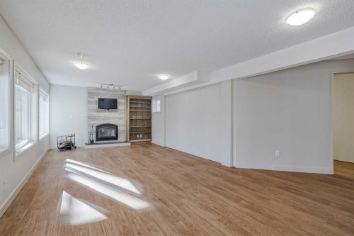 127 Canterbury Court Sw, Calgary, AB - Indoor Photo Showing Other Room With Fireplace