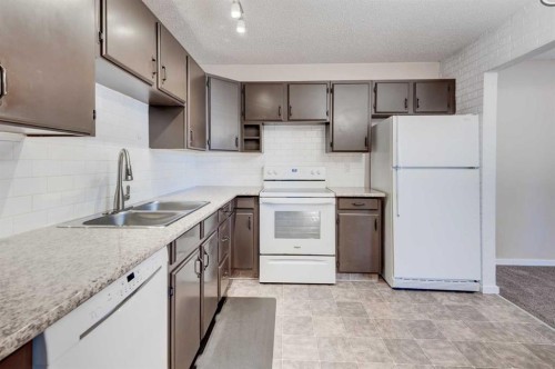 43 Midridge Gardens Se, Calgary, AB - Indoor Photo Showing Kitchen With Double Sink
