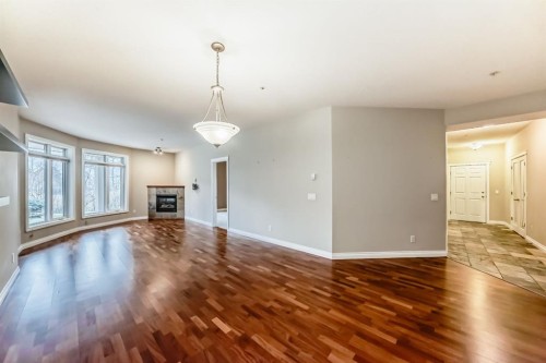 106-6 Hemlock Crescent Sw, Calgary, AB - Indoor Photo Showing Living Room With Fireplace
