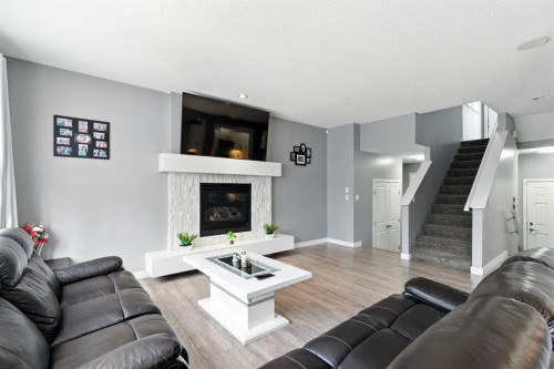 313 Kings Heights Drive Se, Airdrie, AB - Indoor Photo Showing Living Room With Fireplace