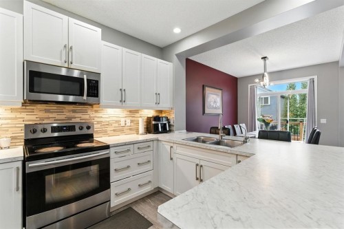 313 Kings Heights Drive Se, Airdrie, AB - Indoor Photo Showing Kitchen With Double Sink With Upgraded Kitchen