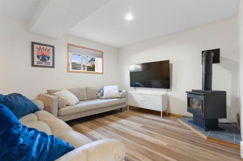 179 Quigley Drive, Cochrane, AB - Indoor Photo Showing Living Room With Fireplace