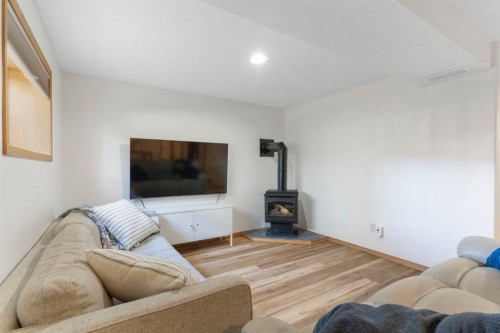 179 Quigley Drive, Cochrane, AB - Indoor Photo Showing Living Room With Fireplace