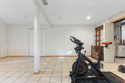 179 Quigley Drive, Cochrane, AB - Indoor Photo Showing Gym Room