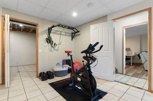 179 Quigley Drive, Cochrane, AB - Indoor Photo Showing Gym Room