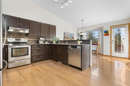 179 Quigley Drive, Cochrane, AB - Indoor Photo Showing Kitchen With Upgraded Kitchen