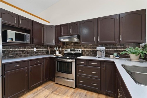 179 Quigley Drive, Cochrane, AB - Indoor Photo Showing Kitchen With Double Sink