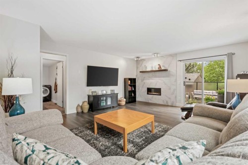 103 Sandarac Place Nw, Calgary, AB - Indoor Photo Showing Living Room With Fireplace